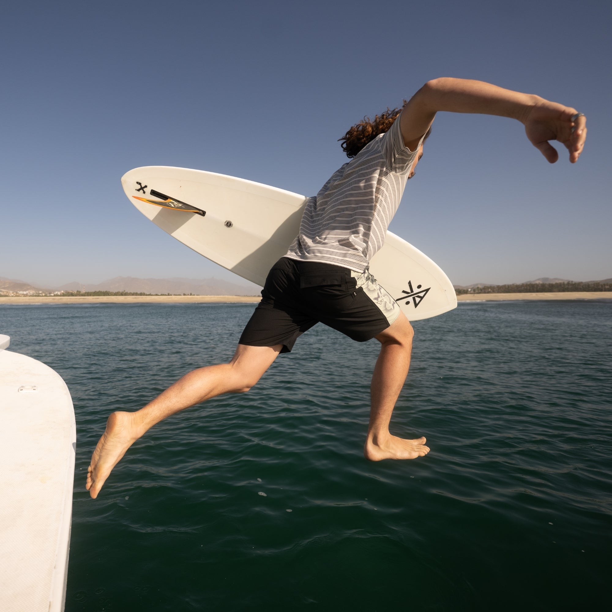 Dynamic surfing scene featuring a surfboard, emblematic of water sports and adventure, perfect for enthusiasts of the outdoor lifestyle.